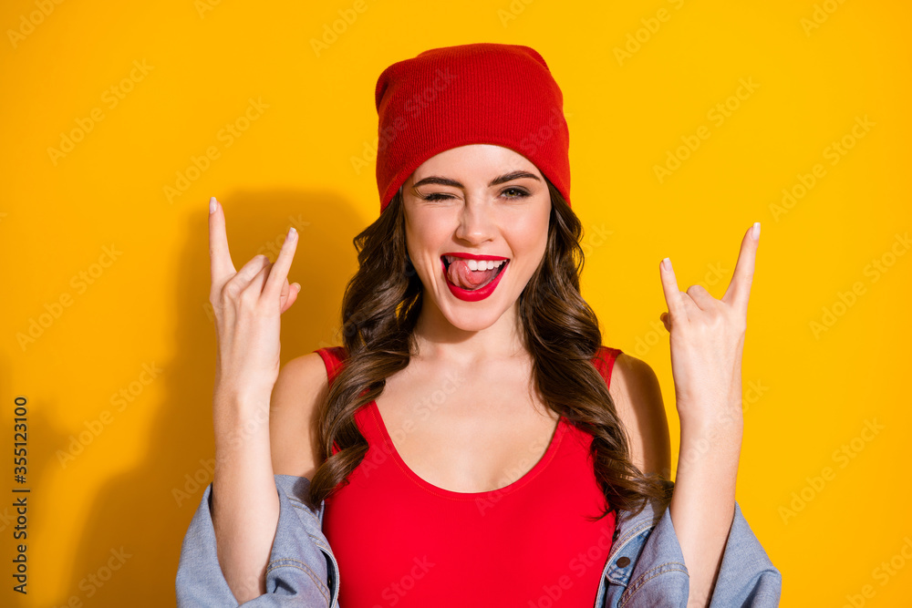 Portrait of lovely sweet cute flirty girl rock concert weekend lover enjoy show horned symbol lick teeth tongue wear jacket singlet headwear isolated over bright color background Portrait of lovely sweet cute flirty girl rock concert weekend lover enjoy show horned symbol lick teeth tongue wear jacket singlet headwear isolated over bright color background