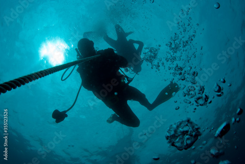 Scuba diver silhouette in surface water. Mediterranean Sea.