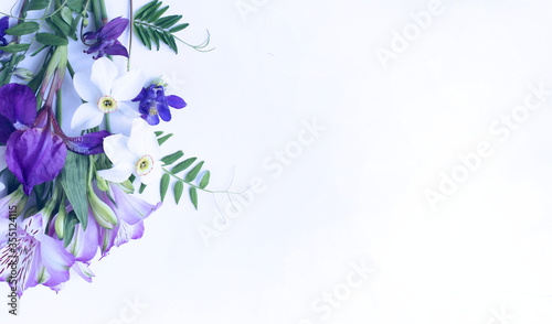 A bouquet of spring flowers - white daffodils, lilac Alstroemeria, purple irises on a white background. Background for greetings, invitations, and postcards. photo