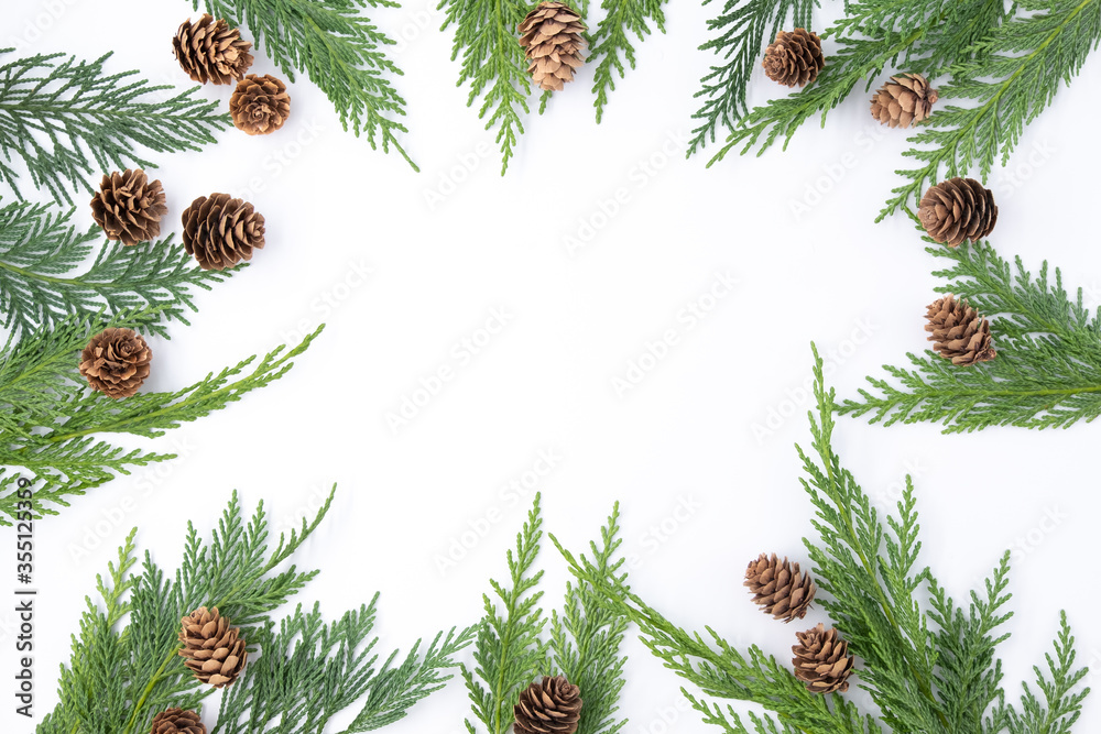Top view of White business table with Christmas decoration including pine branches and pine cones, Merry Christmas and happy new year concept, flat lay with copy space fof text Top view of White business table with Christmas decoration including pine branches and pine cones, Merry Christmas and happy new year concept, flat lay with copy space fof text