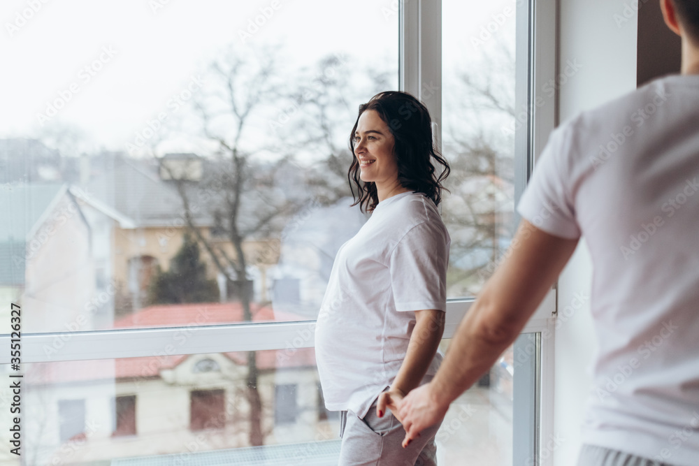 Close up woman and man in love snanding ia a room. Two people holding  hands. Symbol sign sincere feelings, compassion, loved one, say sorry.  Reliable person, trusted friend, true friendship concept Stock