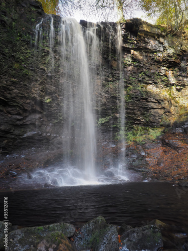 Torrent of water cascading over Whitfield Gill Force waterfall and into an idyllic pool in the woods  Askrigg  Yorkshire Dales  UK