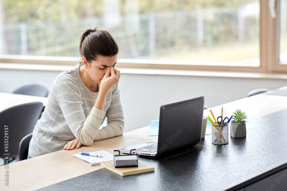 remote job, business and people concept - tired young woman with laptop computer working at home office