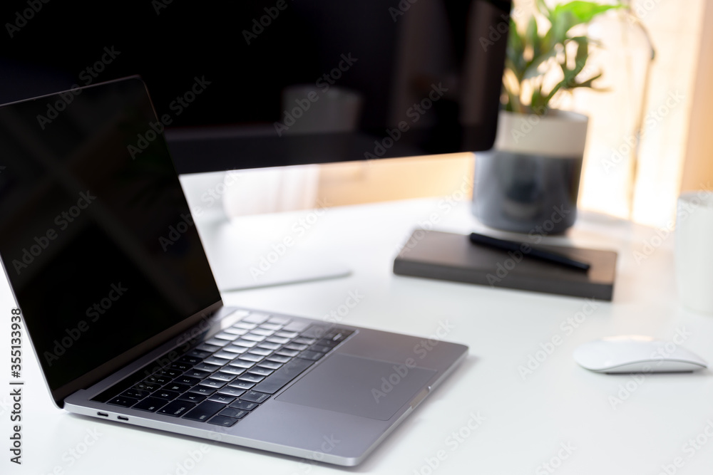 Working creative workspace with computer laptop with coffee cup and notebook, Clean workplace with desktop computer, workspace work from home Working creative workspace with computer laptop with coffee cup and notebook, Clean workplace with desktop computer, workspace work from home