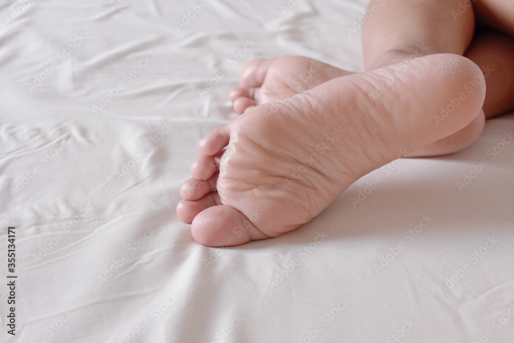 Feet of a woman on bed, sleeping or resting concept for your design work, presentation, website or others. Feet of a woman on bed, sleeping or resting concept for your design work, presentation, website or others.