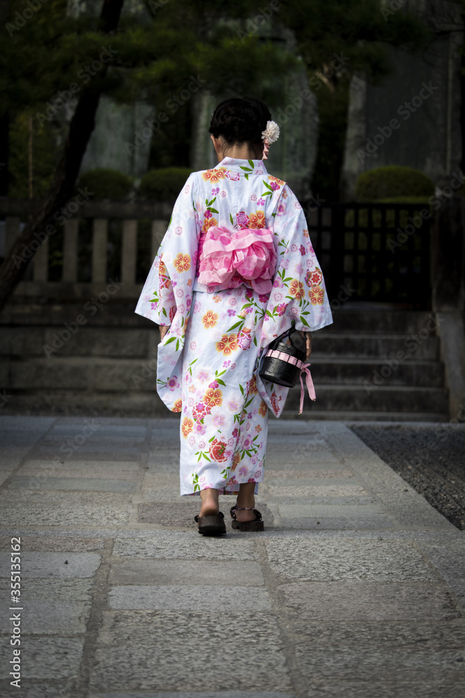Child with kimono walking in Kyoto streets with smile Child with kimono walking in Kyoto streets with smile
