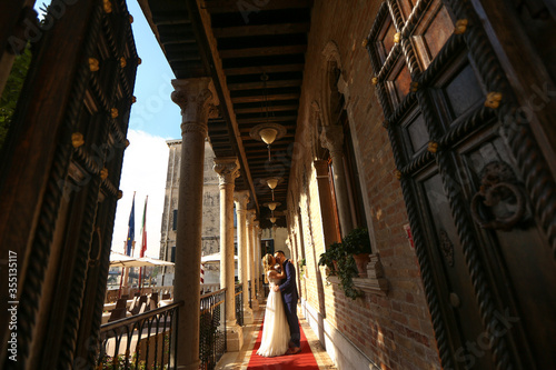 beautiful bride and handsome groom posing in streets of venice