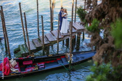 Beautiful wedding couple posing on dock in venice © hreniuca