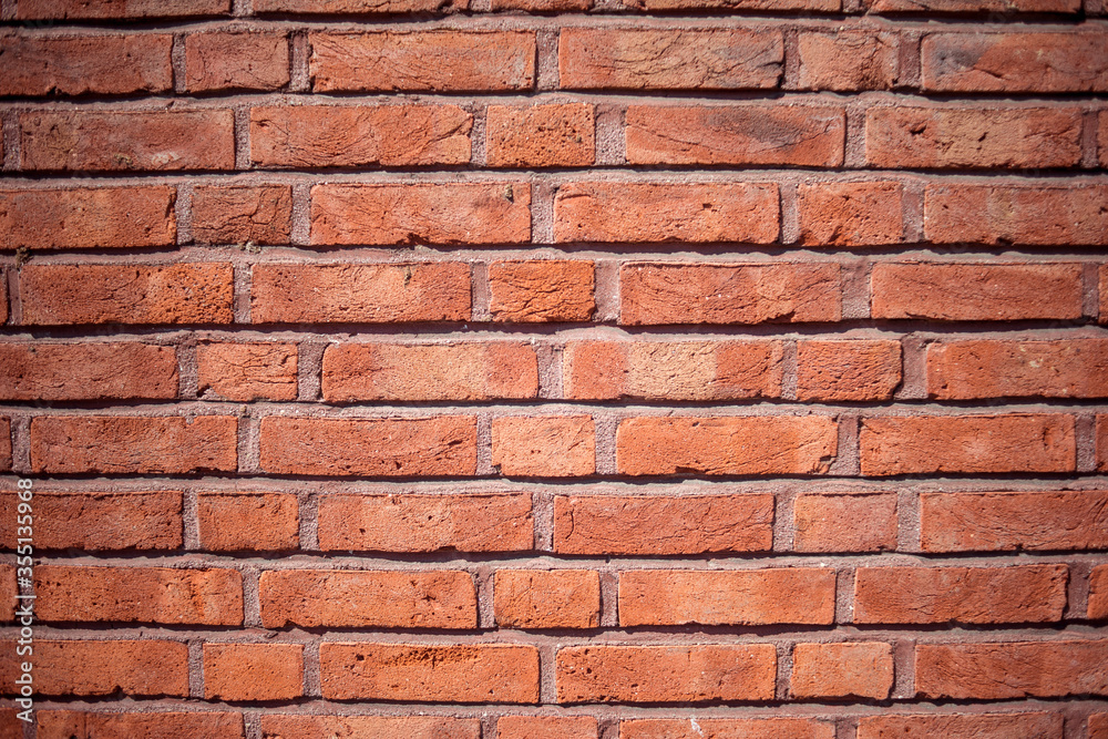 Old red brick wall with lots of character and individual texture.