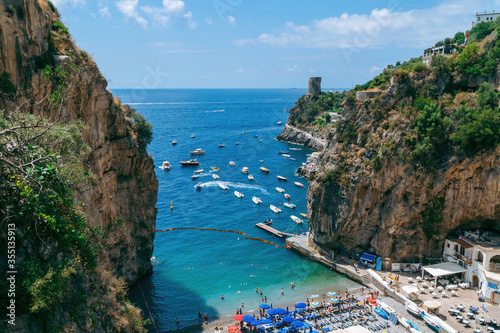 Fototapeta Naklejka Na Ścianę i Meble -  View of the bay, public beach of Marina di Praia. Mountain landscape coast of Italy, Amalfi. Sea and rocks, Tourists and vacations in Europe