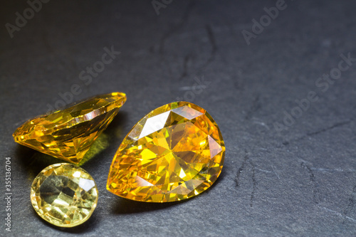 Natural yellow Sapphire gemstone, beautiful yellow gold citrin gemstone isolated on black background, as jewelry background