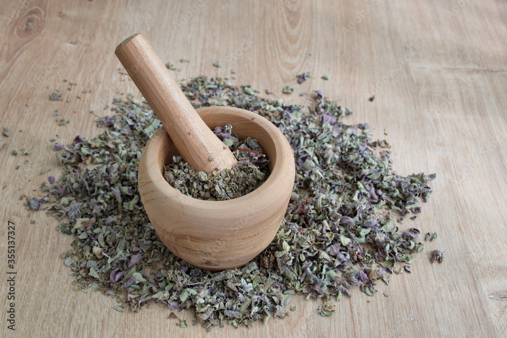 Spice mix in wooden bowl on wooden surface Spice mix in wooden bowl on wooden surface