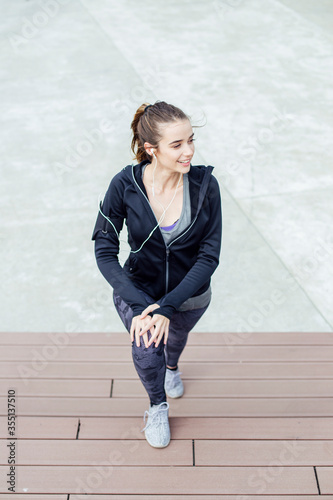 Fit young woman with earpho...