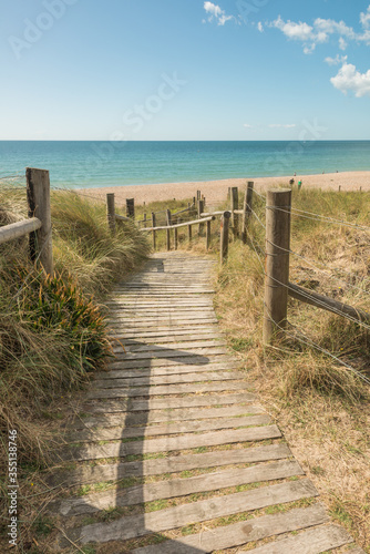 Boardwalk leading to the beach. Scenic coastal view.