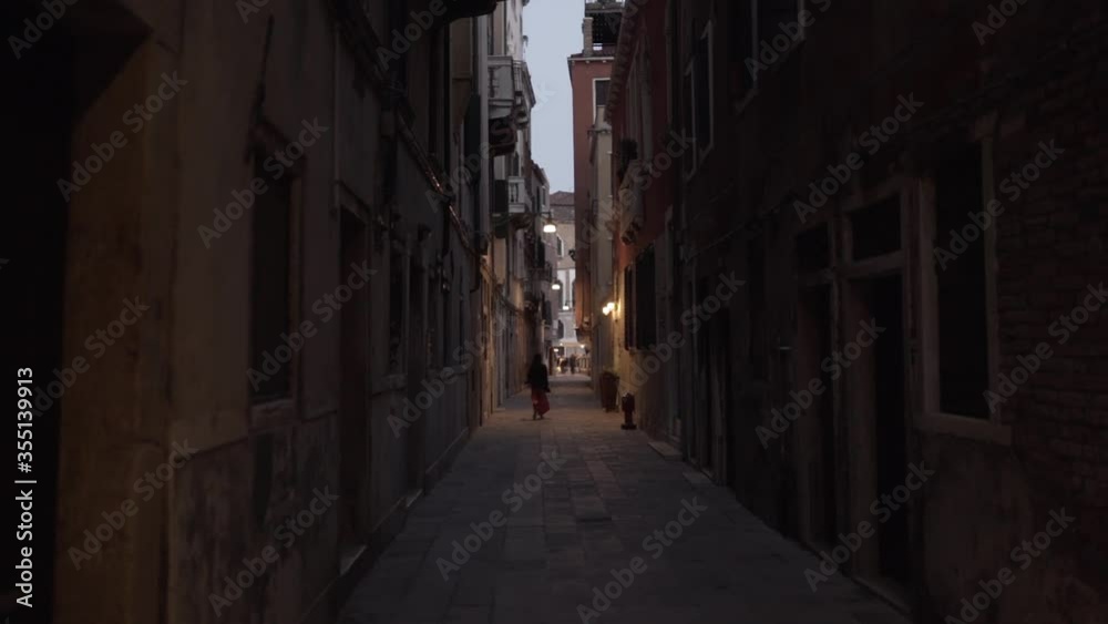 Woman walking alone in an empty alley (slow motion 120fps) Woman walking alone in an empty alley (slow motion 120fps)