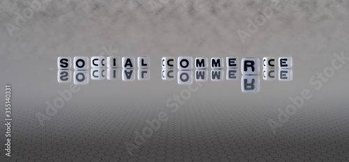 social commerce concept represented by black and white letter cubes on a grey horizon background stretching to infinity