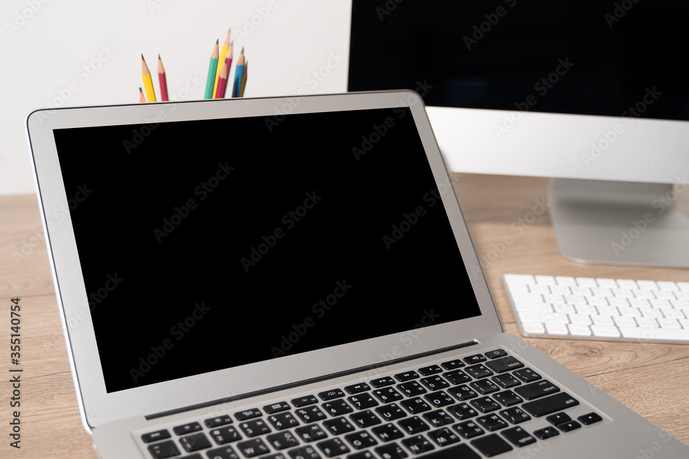 Laptop with blank screen on table. Workspace background new project on laptop computer with blank copy space screen for your advertising text message Laptop with blank screen on table. Workspace background new project on laptop computer with blank copy space screen for your advertising text message