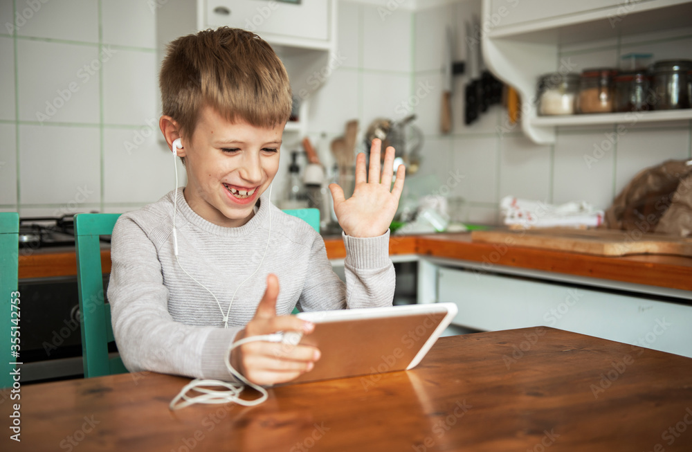 Young boy chatting online on digital tablet Young boy chatting online on digital tablet