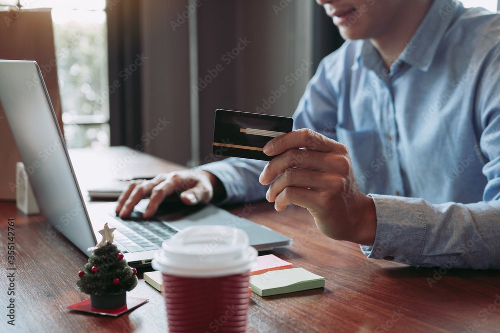 Fototapeta premium Asian man using credit card with shopping online concept at cafe.