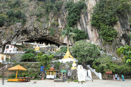 Buddhist temple inside a cave with golden stupas and Buddha statues. Monkeys living in the surroundings. Mahar Sadan Cave, Hpa An, Myanmar - Burma, Southeast Asia photo