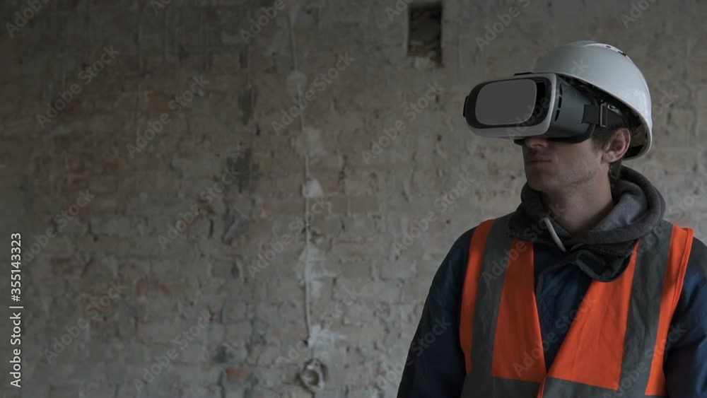 The builder uses virtual reality glasses and plans to reconstruct the building with his own hands. 3D glasses in the construction industry. The builder uses virtual reality glasses and plans to reconstruct the building with his own hands. 3D glasses in the construction industry.