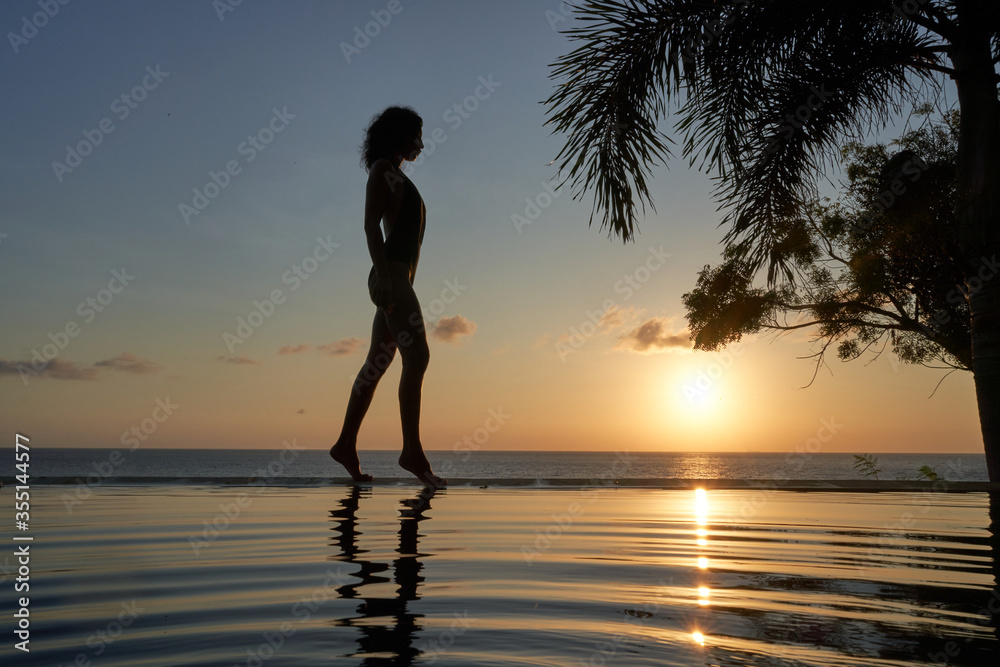 silhouette woman on sunset sunrise with palm tree