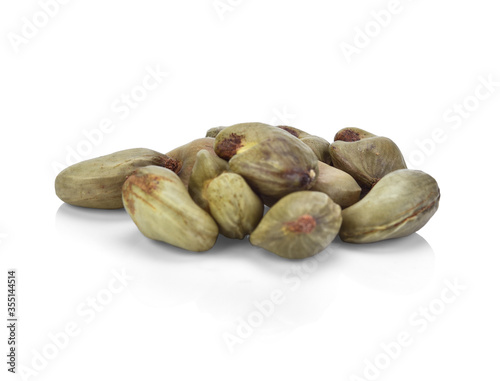Cashew nuts with shell waiting to be processed on white background