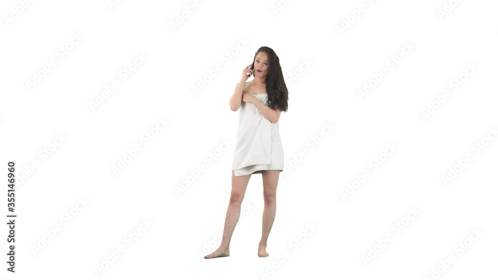 Bored and frustrated young woman in bath towel with wet hair talking on the call phone rolling eyes isolated on solid white background Bored and frustrated young woman in bath towel with wet hair talking on the call phone rolling eyes isolated on solid white background