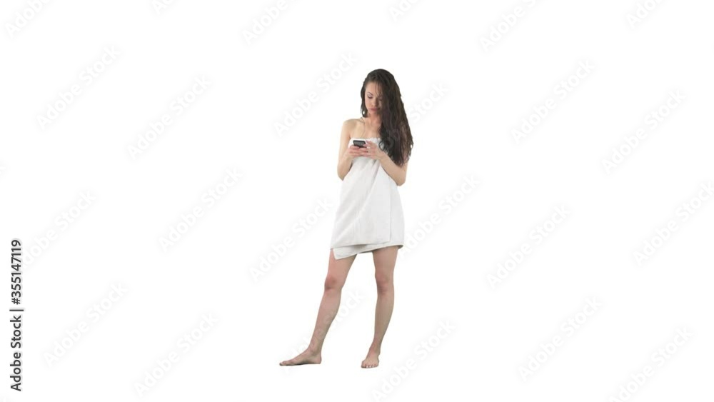 Angry young pretty woman with wet hair using cell phone reading messages on social media isolated on solid white background. Angry young pretty woman with wet hair using cell phone reading messages on social media isolated on solid white background.
