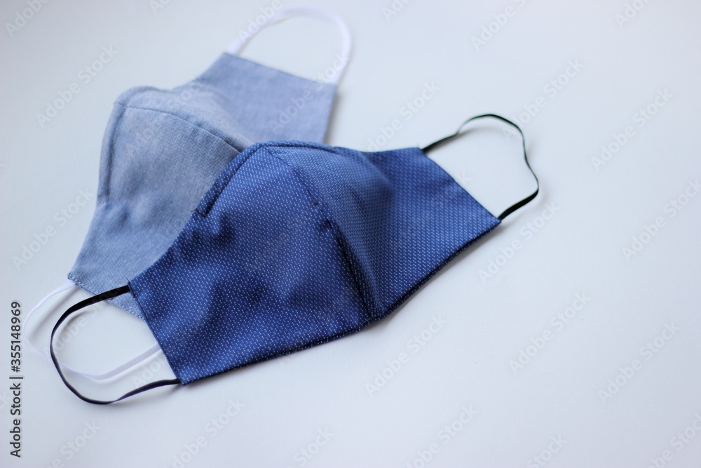 Handmade cotton face mask protective against dust and virus top view. Coronavirus preventive cotton mask. DIY concept. Handmade cotton face mask protective against dust and virus top view. Coronavirus preventive cotton mask. DIY concept.