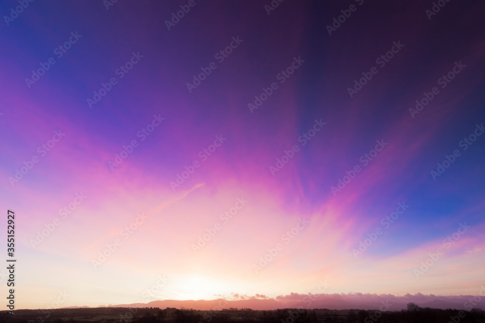 Beautiful sunrise skyscape behind the Snowdonia Mountain Range, North Wales