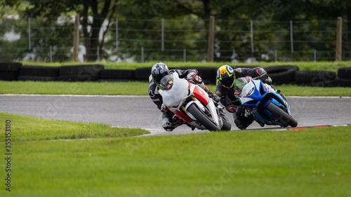 A shot of two racing bikes cornering as they circuit a track