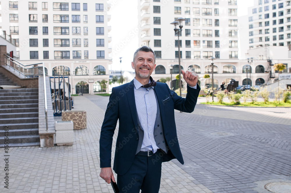 Cheerful businessman thumbs up posing and smiling at camera