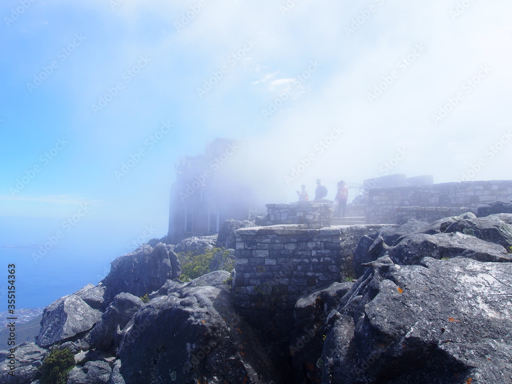 People wrapped in clouds at the top of a mountain, Table Mountain, Cape Town, South Africa