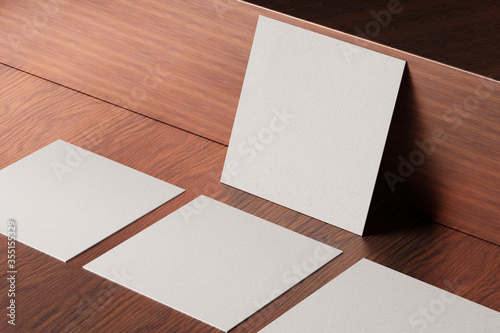 White square paper business card mockup on wooden table 3D illustration rendering