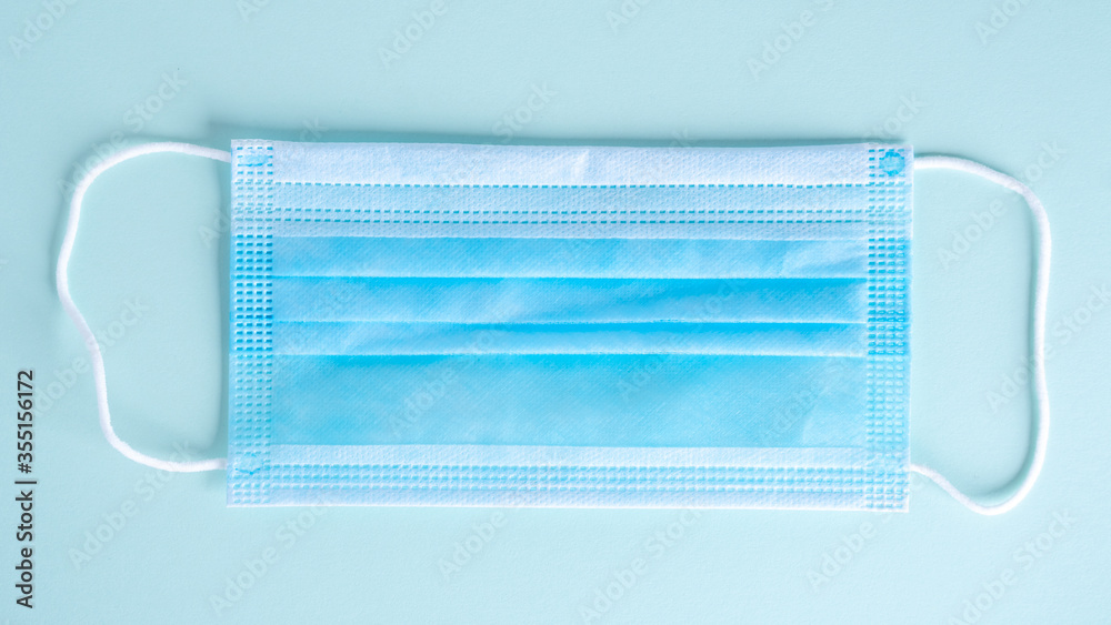 Medical protective mask isolated on blue background Medical protective mask isolated on blue background