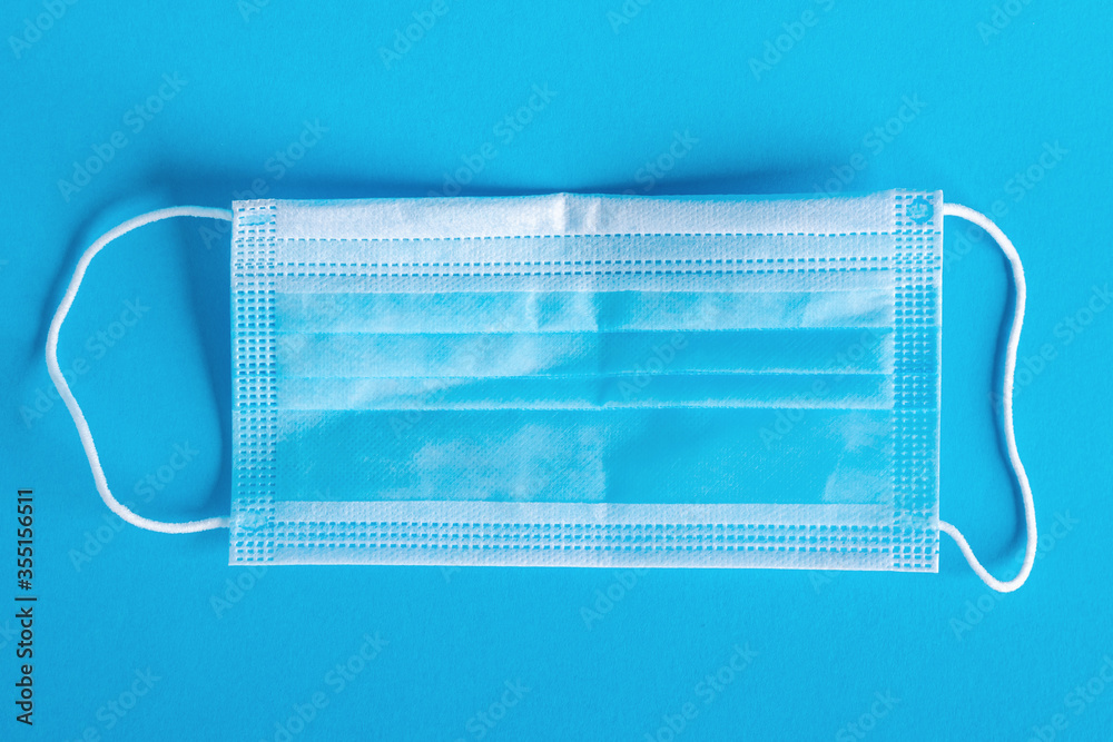 Medical protective mask isolated on blue background Medical protective mask isolated on blue background