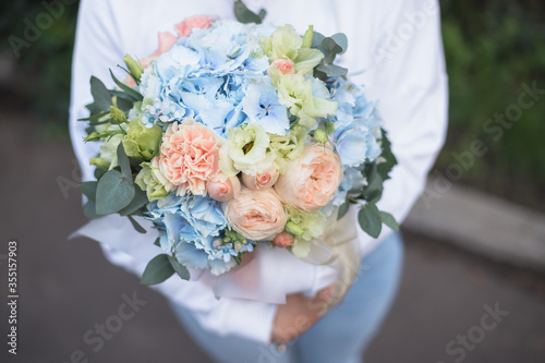 Wallpaper Mural Flower arrangement in a purple hat box was created by a florist for a wedding gift. Flower bouquet of purple hydrangea, white freesia, pink ranunculus asiaticus, eustoma flowers, roses and eucalyptus Torontodigital.ca