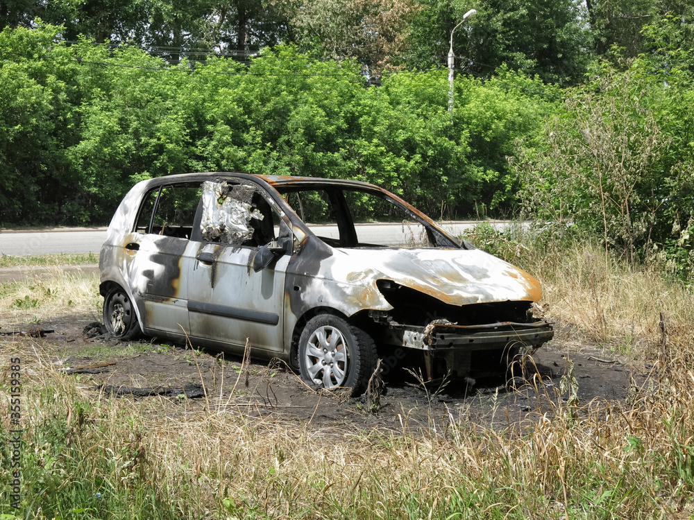 Car burned from poplar fluff and dry grass