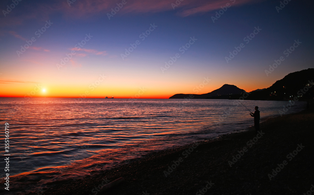 Spectacular romantic sunset on Mediterranean coast, clouds in colorful sky, Bar, Montenegro