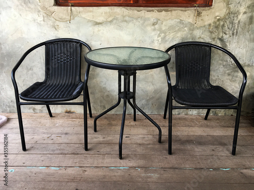 Double chair with a table in black and brown background