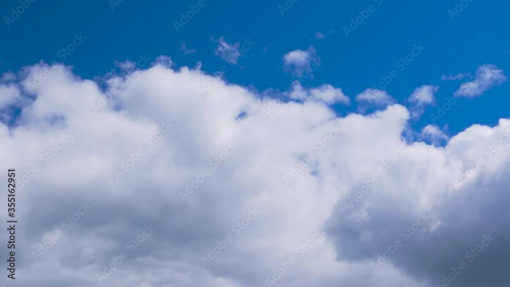 Thick white-gray clouds move quickly across the blue sky. Timelapse Thick white-gray clouds move quickly across the blue sky. Timelapse