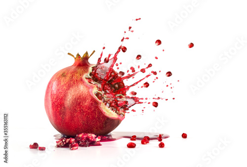 Fotografija Pomegranate explosion juice seeds on a white background