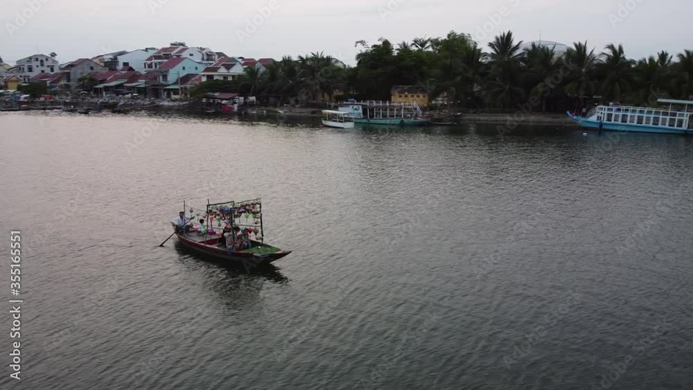Aerial view of a tourist boat sailing in the Thu Bon river in Hoi An old town. Aerial view of a tourist boat sailing in the Thu Bon river in Hoi An old town.