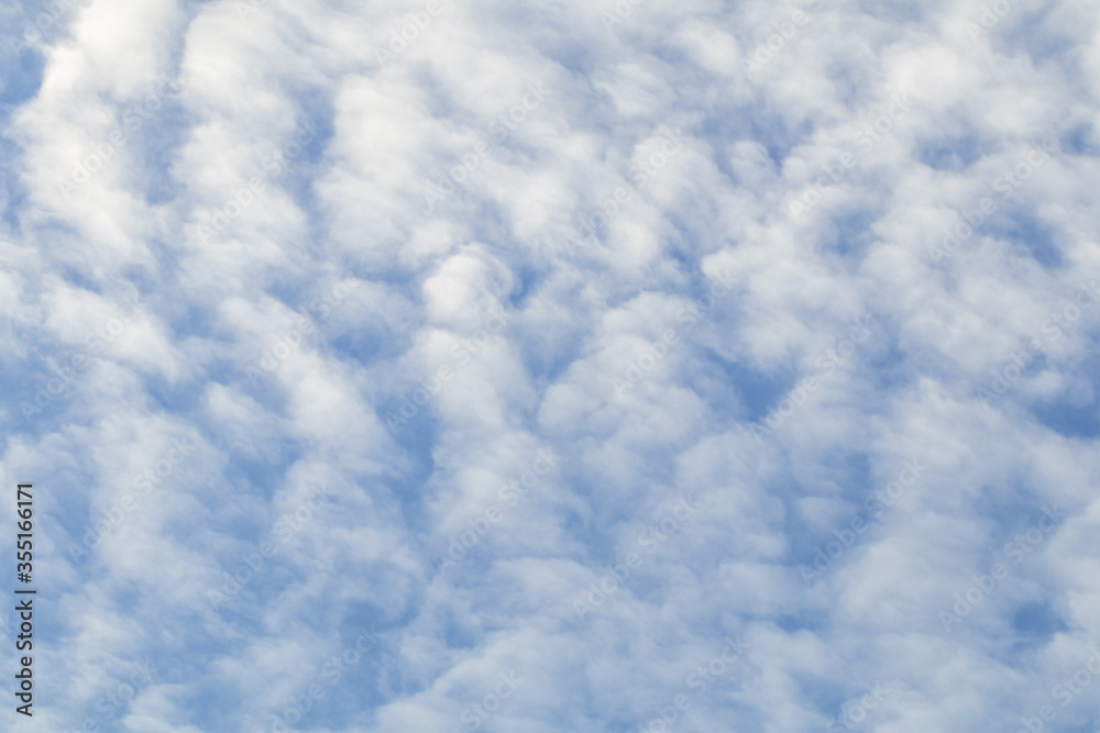 Deep blue sky and white cloud background.Altocumulus soft white clouds against blue sky. Deep blue sky and white cloud background.Altocumulus soft white clouds against blue sky.