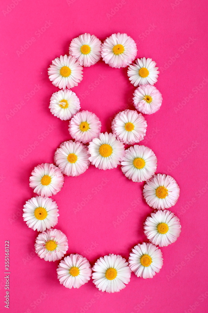 The number 8 is written in white pink flowers on a bright pink background. The number eight is written in fresh flowers highlighted on a pink background. Arabic numerals inlaid with daisies.