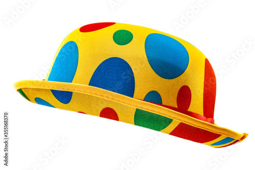 Humorous headgear concept with floating clown bowler hat in red, blue, green and yellow colors  isolated on white background with clipping path cutout using the ghost mannequin technique