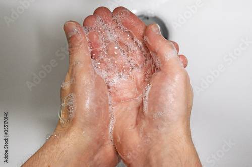 Man washing his hands with soap  wash hands concept soap foam closeup  virus prevention