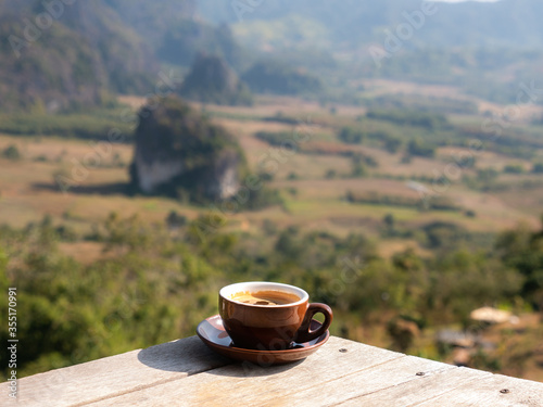 Cofffee Cup on The Wooden Table behind The Mountain