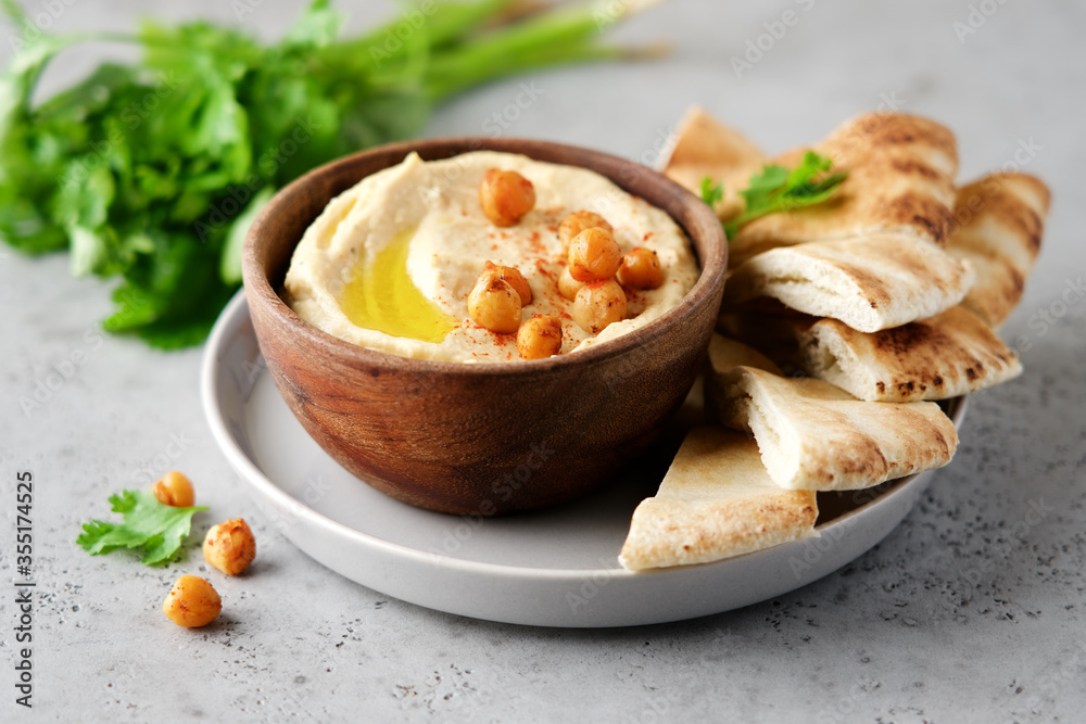 Hummus plate with pita bread. Middle Eastern traditional appetiser. Authentic arab cuisine